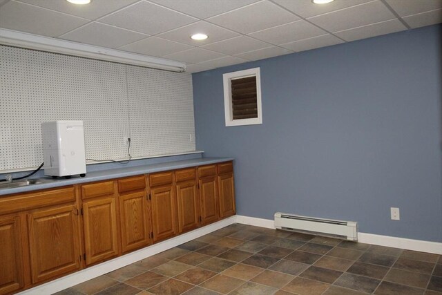 kitchen with a paneled ceiling and a baseboard radiator