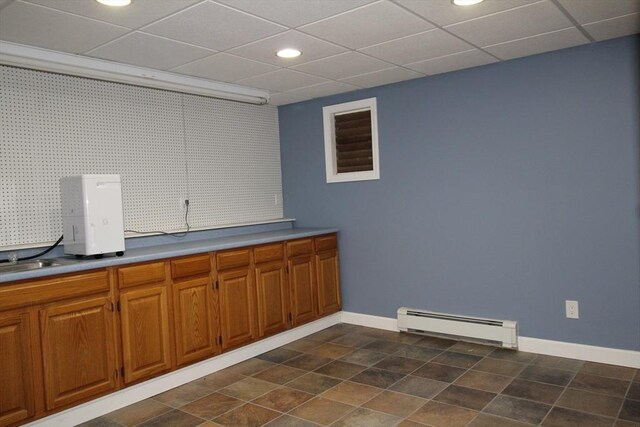 interior space featuring a sink, baseboards, recessed lighting, and a baseboard heating unit
