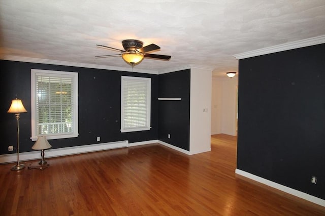 empty room with baseboard heating, wood finished floors, baseboards, and a ceiling fan