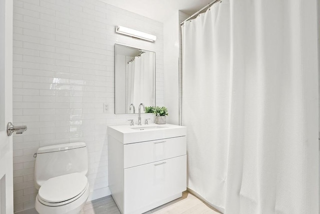 300 Blvd 3I, Boston, MA 02210 - bathroom featuring tile walls, vanity, toilet, and a shower with shower curtain