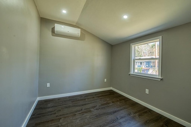 22 3rd, Lakeville, MA 02347 - spare room featuring vaulted ceiling, dark wood finished floors, baseboards, an AC wall unit, and recessed lighting