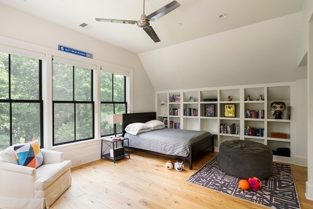 bedroom featuring ceiling fan, wood-type flooring, and lofted ceiling