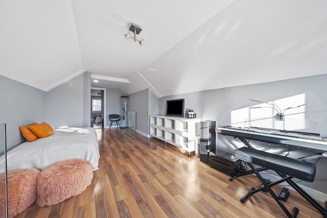 bedroom with wood-type flooring and lofted ceiling