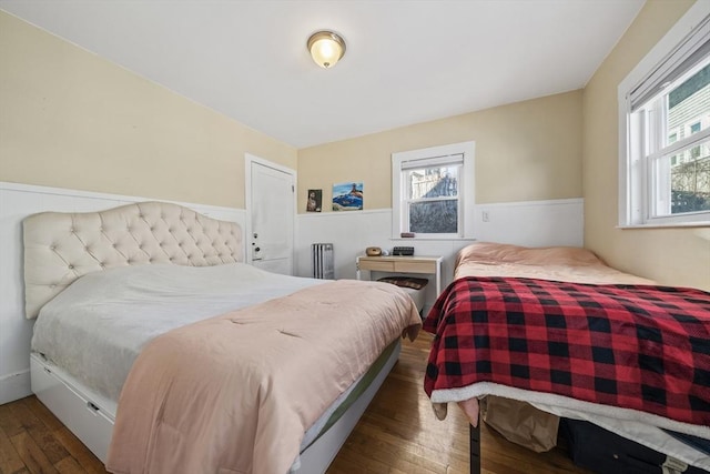 bedroom with dark hardwood / wood-style floors