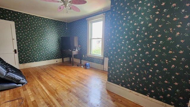132 Institute Rd, Worcester, MA 01602 - spare room with wood finished floors, a ceiling fan, wallpapered walls, and ornamental molding
