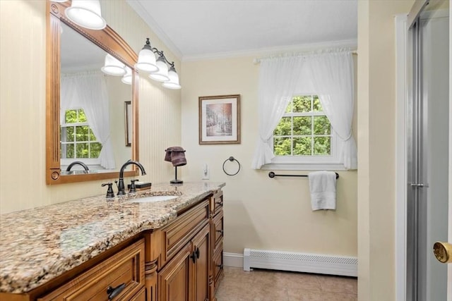 bathroom featuring baseboard heating, baseboards, tile patterned flooring, crown molding, and vanity