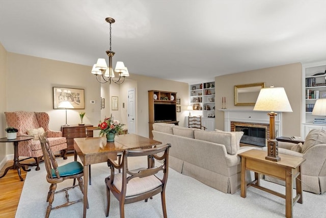 5 Myrtle St Unit 3, Boston, MA 02114 - dining space featuring a chandelier, a brick fireplace, built in features, and light wood-type flooring