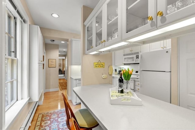 5 Myrtle St Unit 3, Boston, MA 02114 - kitchen featuring white appliances, white cabinetry, light countertops, light wood finished floors, and recessed lighting