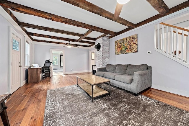 living area with wood-type flooring, beam ceiling, baseboards, ceiling fan, and coffered ceiling