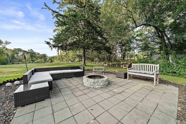 view of patio with an outdoor living space with a fire pit