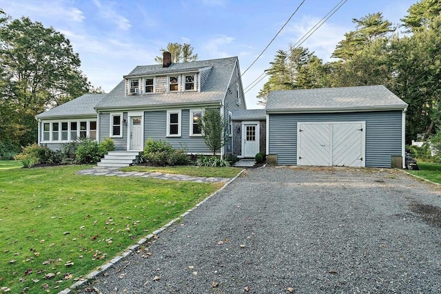 view of front of property featuring driveway, a chimney, and a front yard