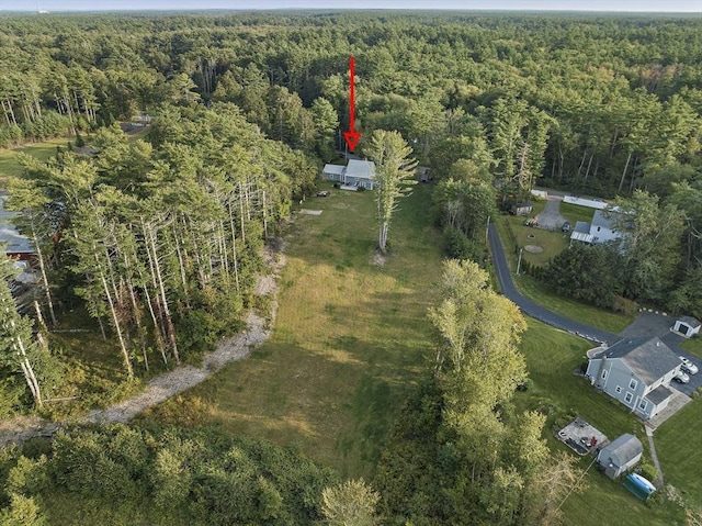 birds eye view of property featuring a view of trees