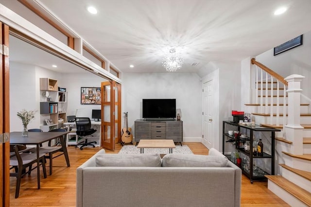 living area featuring stairway, recessed lighting, and light wood-style flooring