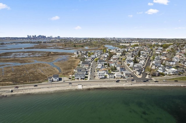 aerial overview of property's location featuring a large body of water and nearby suburban area