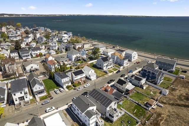 aerial view of property's location featuring a large body of water and nearby suburban area