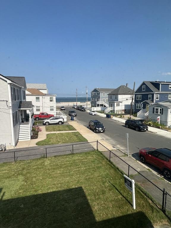 view of yard featuring a residential view and a water view