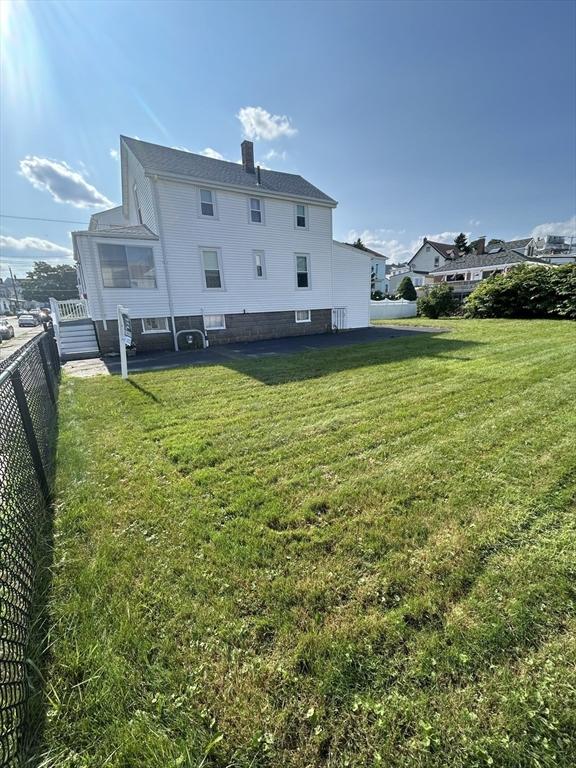 rear view of property featuring a chimney