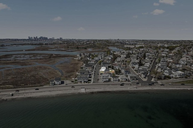 view of property location with a nearby body of water and nearby urban area