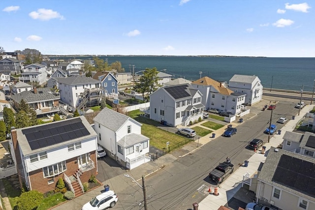 aerial view of residential area featuring a nearby body of water
