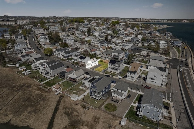view of property location featuring a large body of water and nearby suburban area