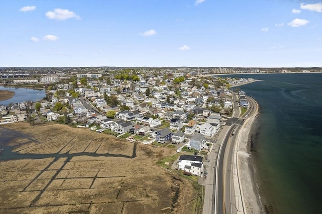 aerial overview of property's location with a nearby body of water and nearby suburban area