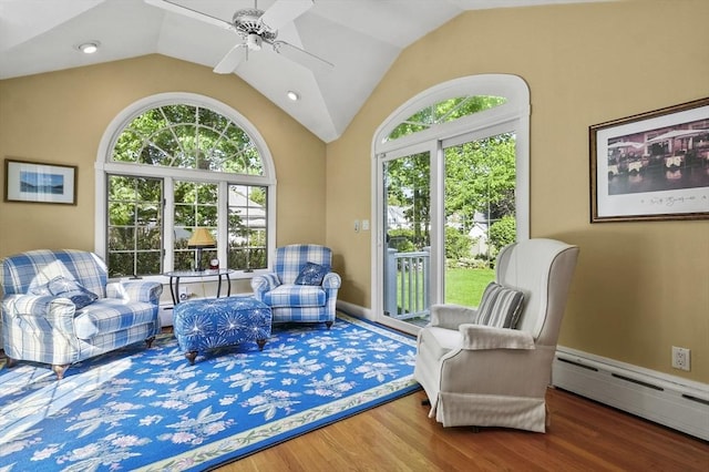 sitting room with wood finished floors, ceiling fan, lofted ceiling, a baseboard radiator, and recessed lighting