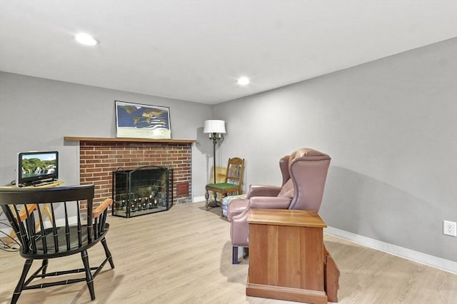 sitting room featuring light wood finished floors, a fireplace, recessed lighting, and baseboards