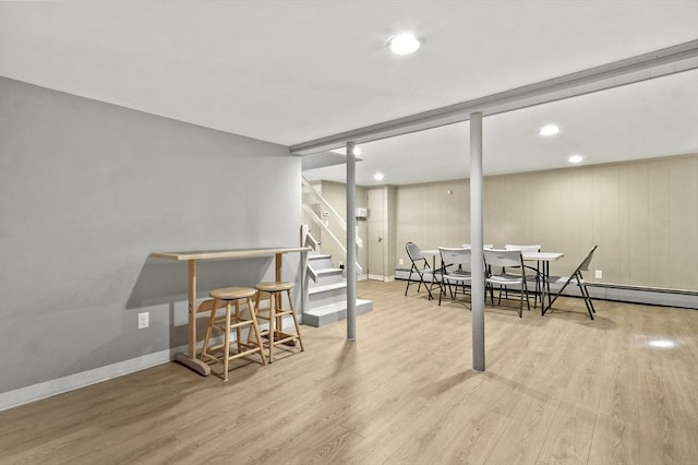 finished basement featuring wood finished floors, stairway, baseboards, and recessed lighting