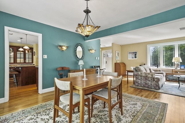 dining room featuring wood finished floors and baseboards