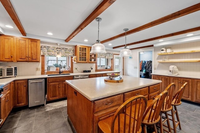 kitchen with beam ceiling, decorative backsplash, sink, and a kitchen island