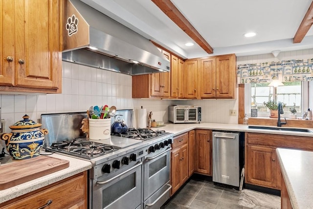 kitchen with beamed ceiling, stainless steel appliances, extractor fan, and sink