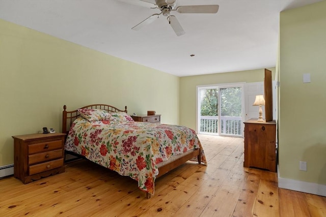 bedroom with ceiling fan, access to exterior, baseboard heating, and light hardwood / wood-style floors