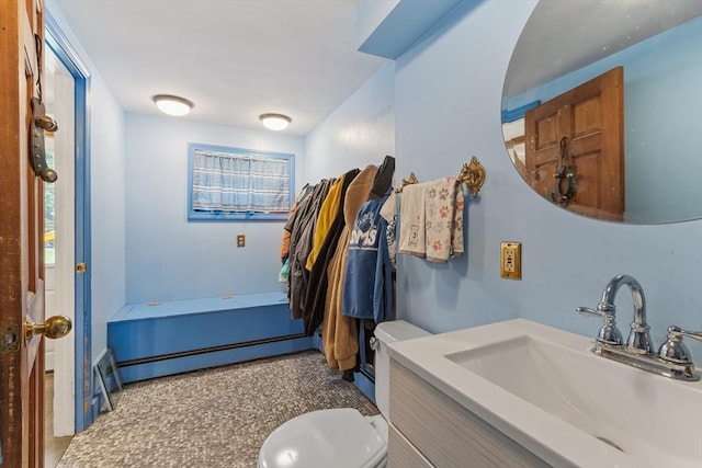 bathroom featuring baseboard heating and vanity