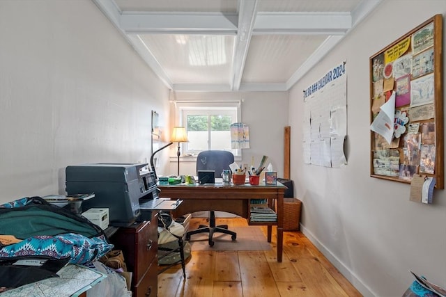 home office with wood-type flooring and beamed ceiling