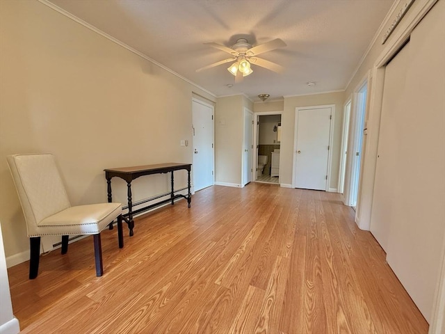 174 Upper County Unit 2-15, Dennis, MA 02639 - unfurnished room featuring a ceiling fan, light wood finished floors, ornamental molding, baseboards, and a baseboard radiator