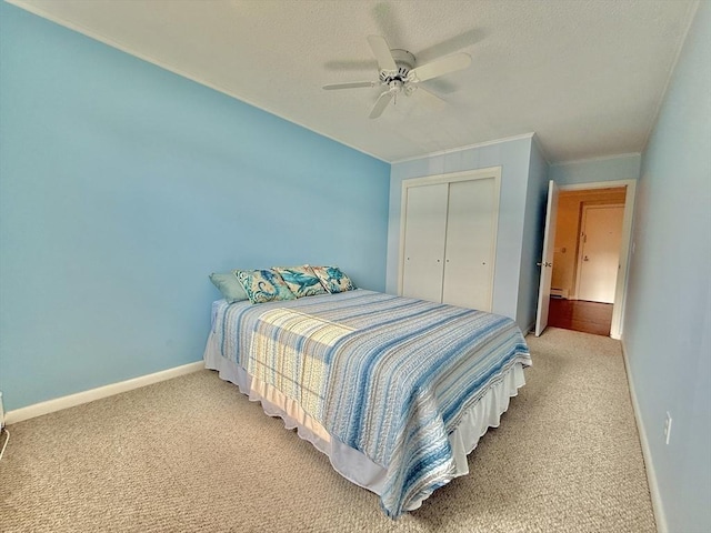 174 Upper County Unit 2-15, Dennis, MA 02639 - bedroom featuring light carpet, a closet, baseboard heating, baseboards, and a textured ceiling