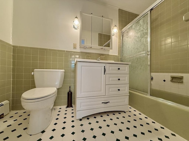 174 Upper County Unit 2-15, Dennis, MA 02639 - bathroom featuring tile walls, vanity, toilet, enclosed tub / shower combo, and tile patterned floors