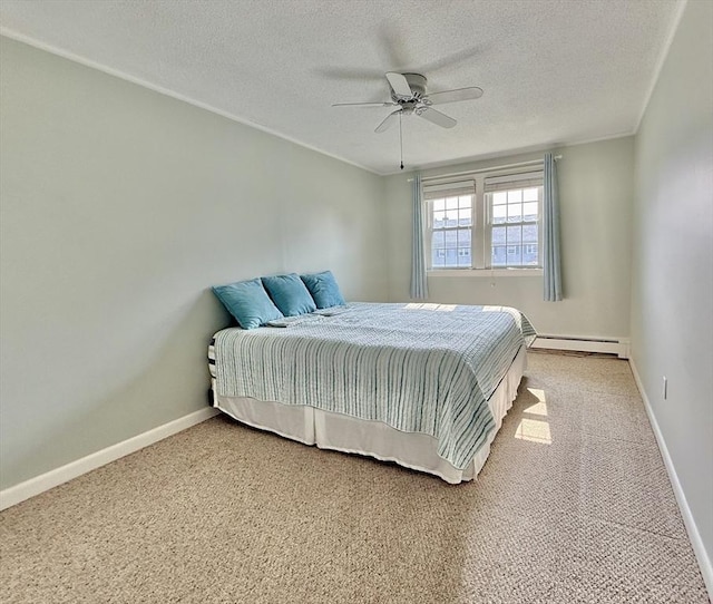 174 Upper County Unit 2-15, Dennis, MA 02639 - bedroom featuring a baseboard radiator, a textured ceiling, carpet, baseboards, and a ceiling fan