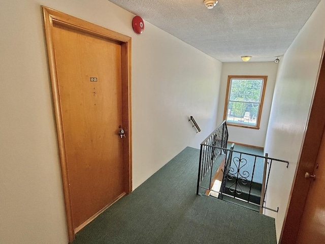174 Upper County Unit 2-15, Dennis, MA 02639 - corridor with an upstairs landing, carpet, and a textured ceiling