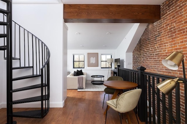 211 W Springfield St, Boston, MA 02118 - dining room featuring stairs, wood finished floors, baseboards, and brick wall