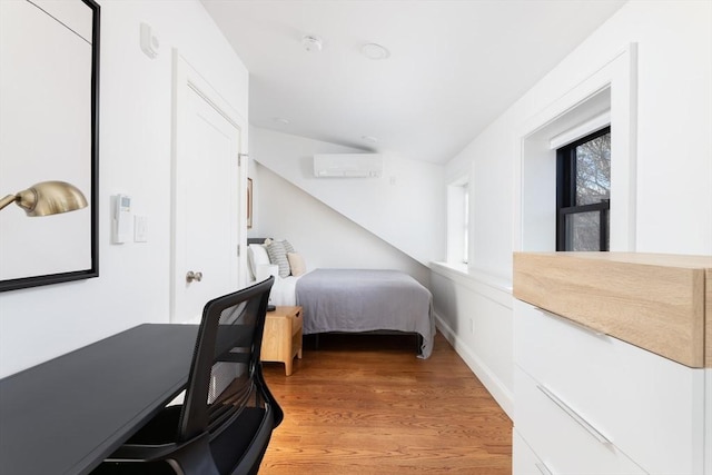 211 W Springfield St, Boston, MA 02118 - bedroom featuring an AC wall unit and light wood finished floors