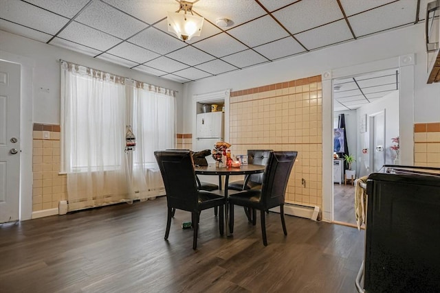 19-21 Pleasant Ter, Lawrence, MA 01841 - dining room featuring tile walls, dark wood-type flooring, a drop ceiling, and baseboard heating