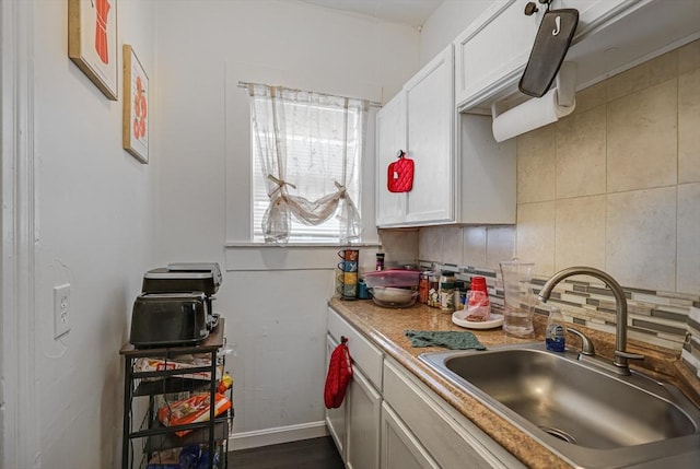 19-21 Pleasant Ter, Lawrence, MA 01841 - kitchen with backsplash, light countertops, white cabinets, and dark wood-type flooring