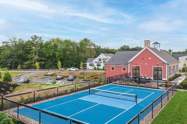 view of tennis court featuring fence