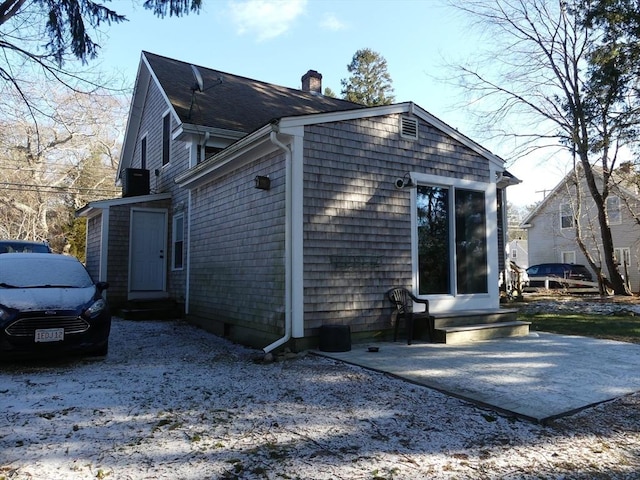 view of side of home with a patio