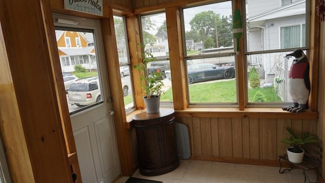 32 Bristol St, Ludlow, MA 01056 - doorway featuring light tile patterned floors and wooden walls