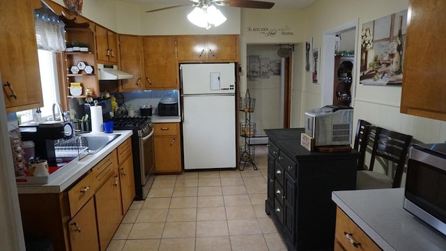 32 Bristol St, Ludlow, MA 01056 - kitchen with stainless steel appliances, brown cabinets, ceiling fan, light countertops, and range hood
