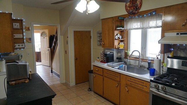 32 Bristol St, Ludlow, MA 01056 - kitchen featuring under cabinet range hood, stainless steel range with gas cooktop, a sink, light tile patterned floors, and open shelves