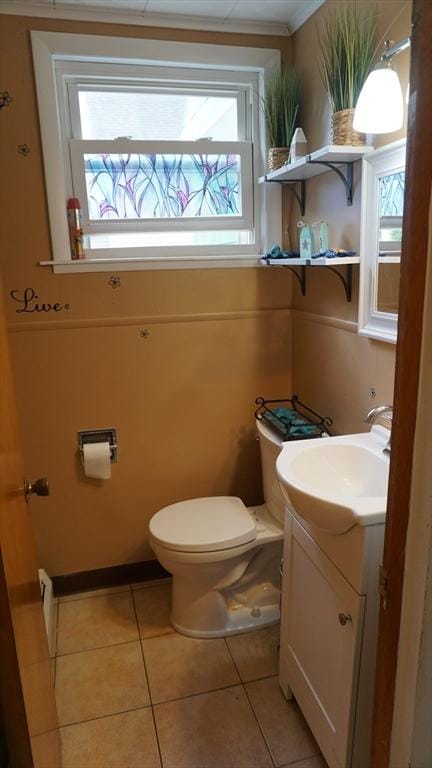 32 Bristol St, Ludlow, MA 01056 - half bathroom featuring plenty of natural light, toilet, vanity, and tile patterned flooring