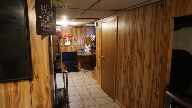 32 Bristol St, Ludlow, MA 01056 - corridor featuring wooden walls, tile patterned floors, and a paneled ceiling
